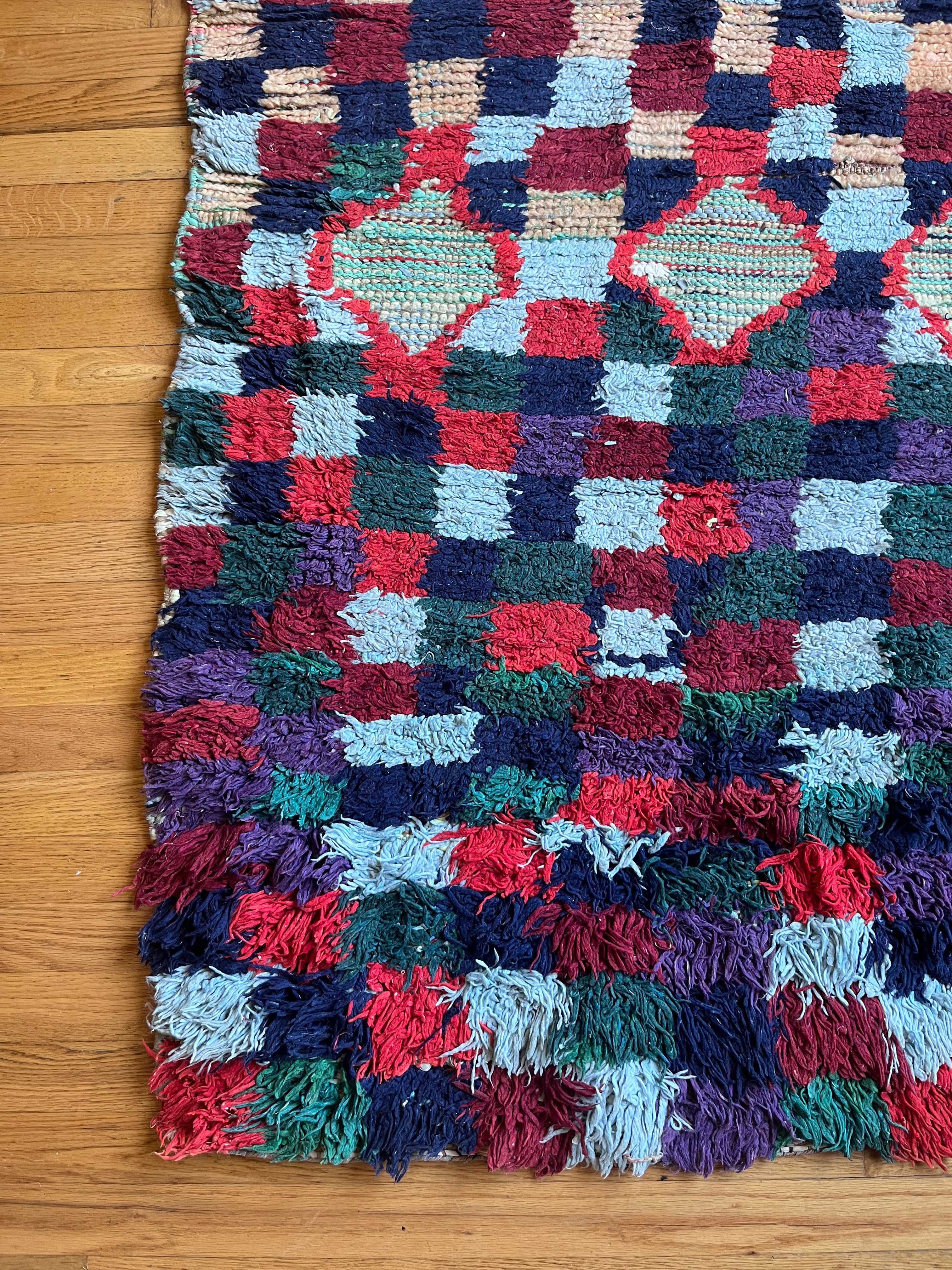 Multicolored textured rug on a wooden floor