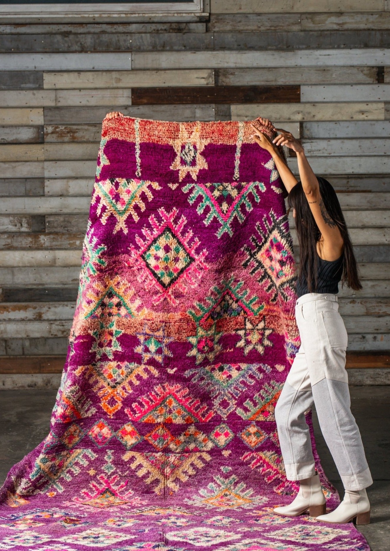 girl dances with delight from the magnetic energy she feels from the authentic moroccan rug. The colors are energizing and playful and they make her feel happy inside. 